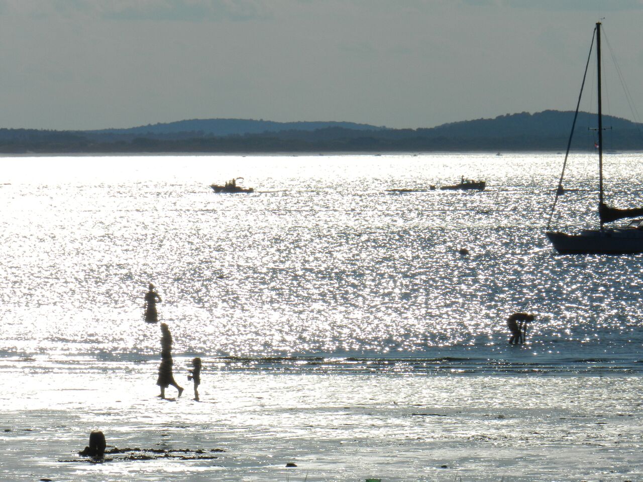  People enjoying the mica sand beach at low tide 