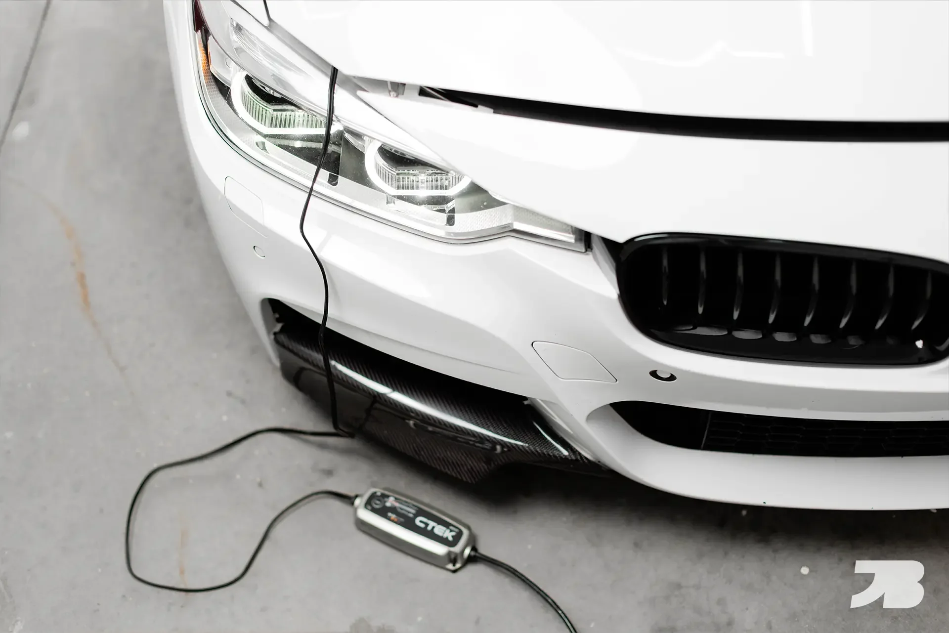 BMW F30 3 Series with hood popped charging