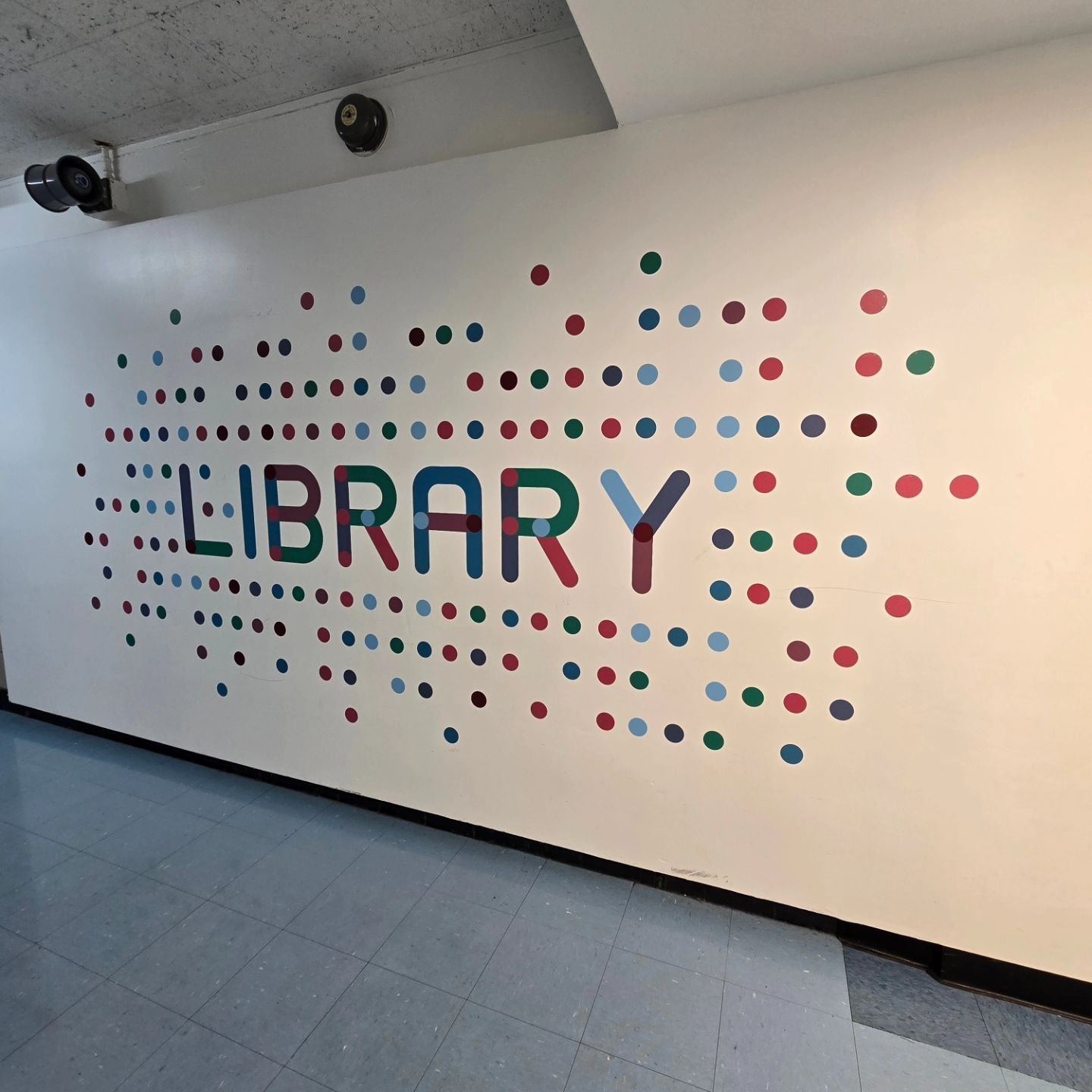 Custom digital printed and contour cut adhesive vinyl graphics applied onto interior wall of an elementary school in NYC