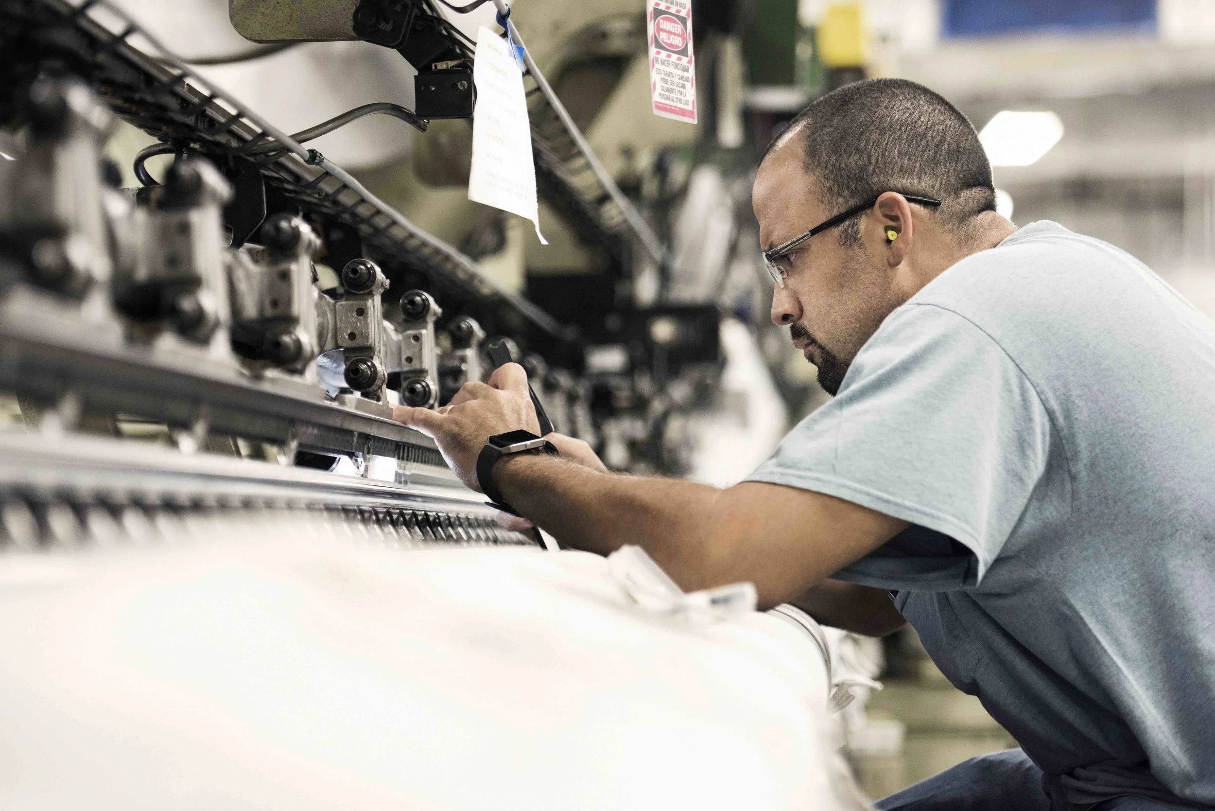 Fairystone Fabrics employee working on factory equipment