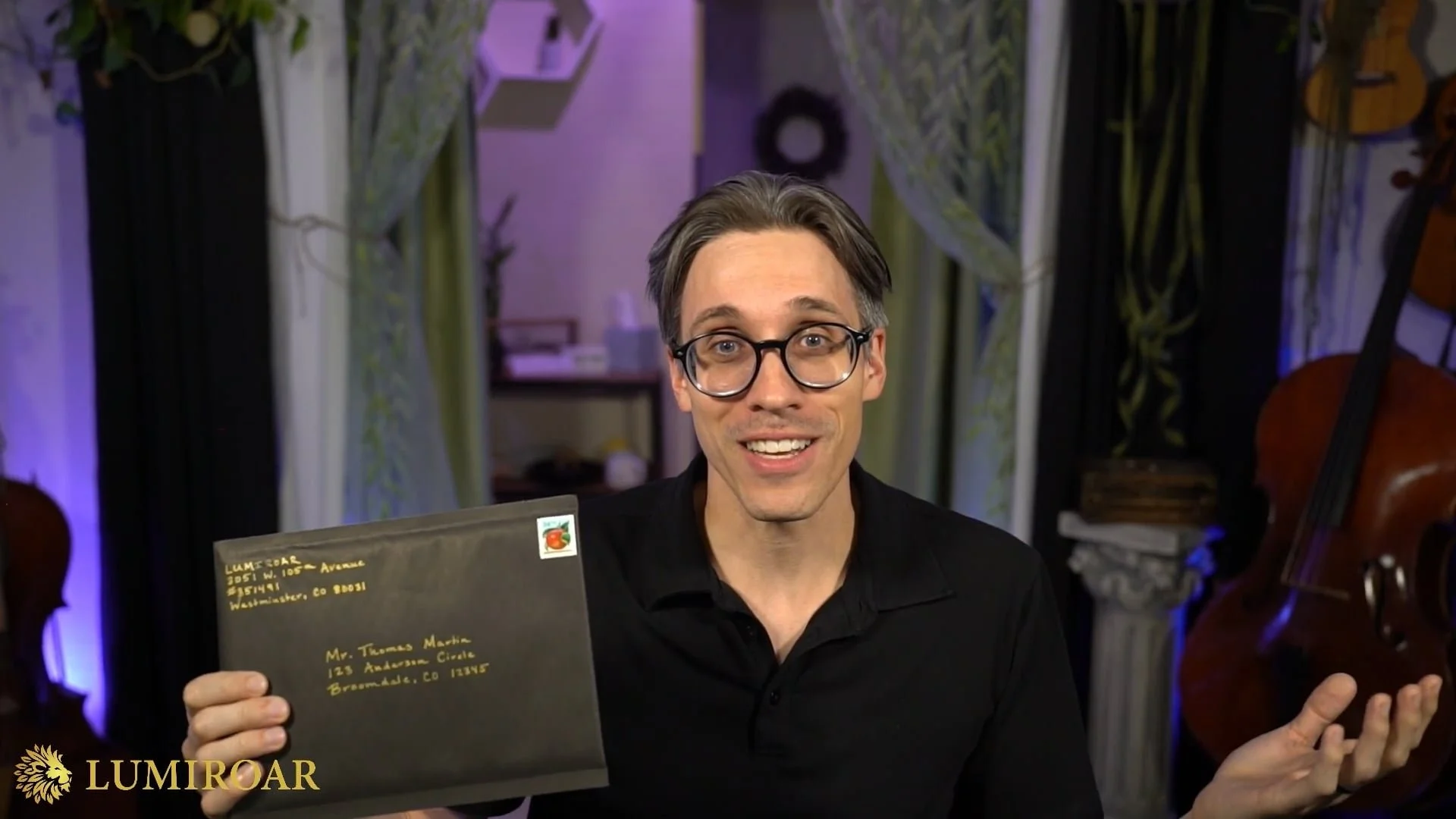 Michael Linert showing the Lyriwave black outer envelope with gold handwritten address.