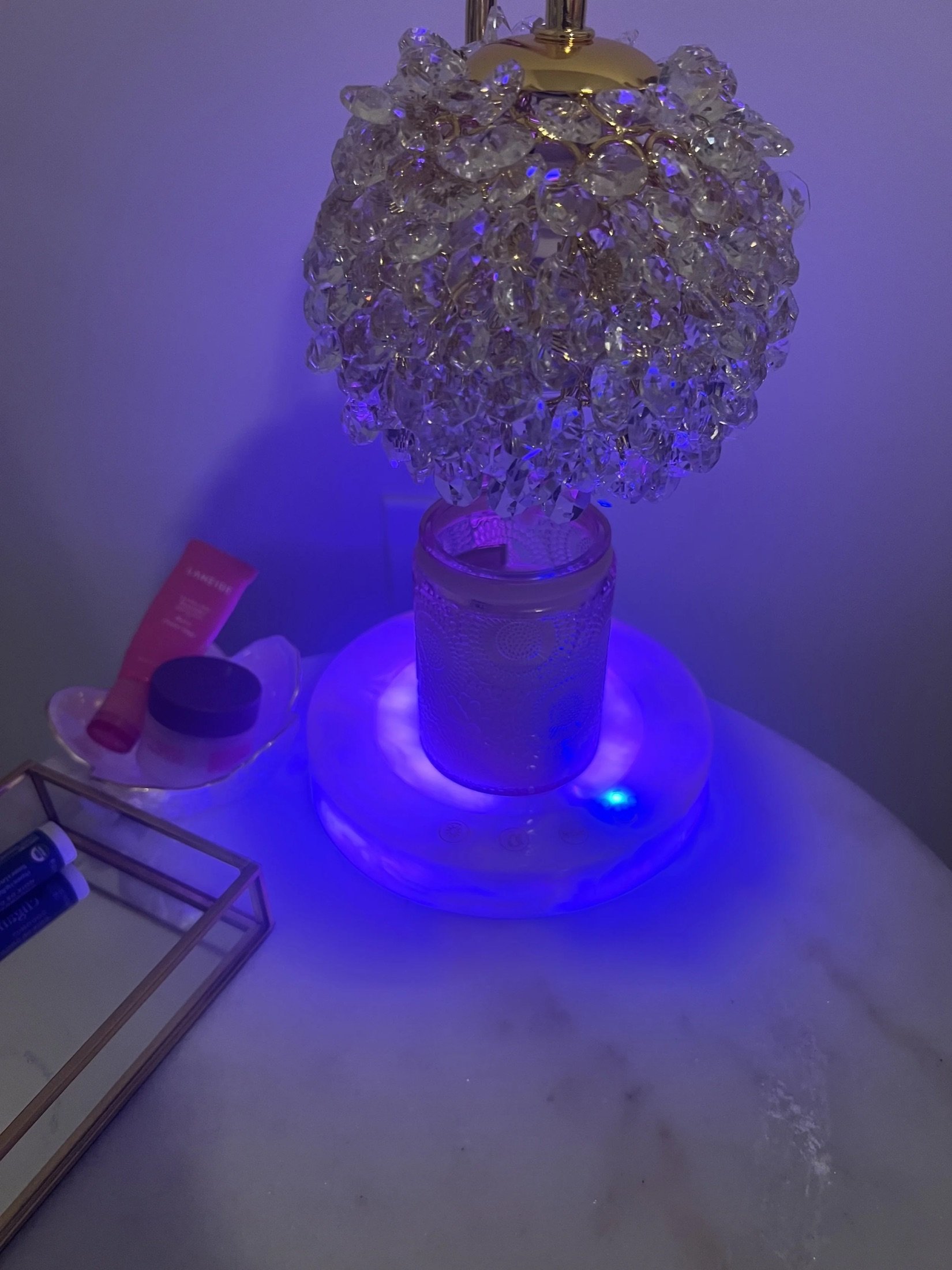 Crystal candle warmer lamp glowing purple at night