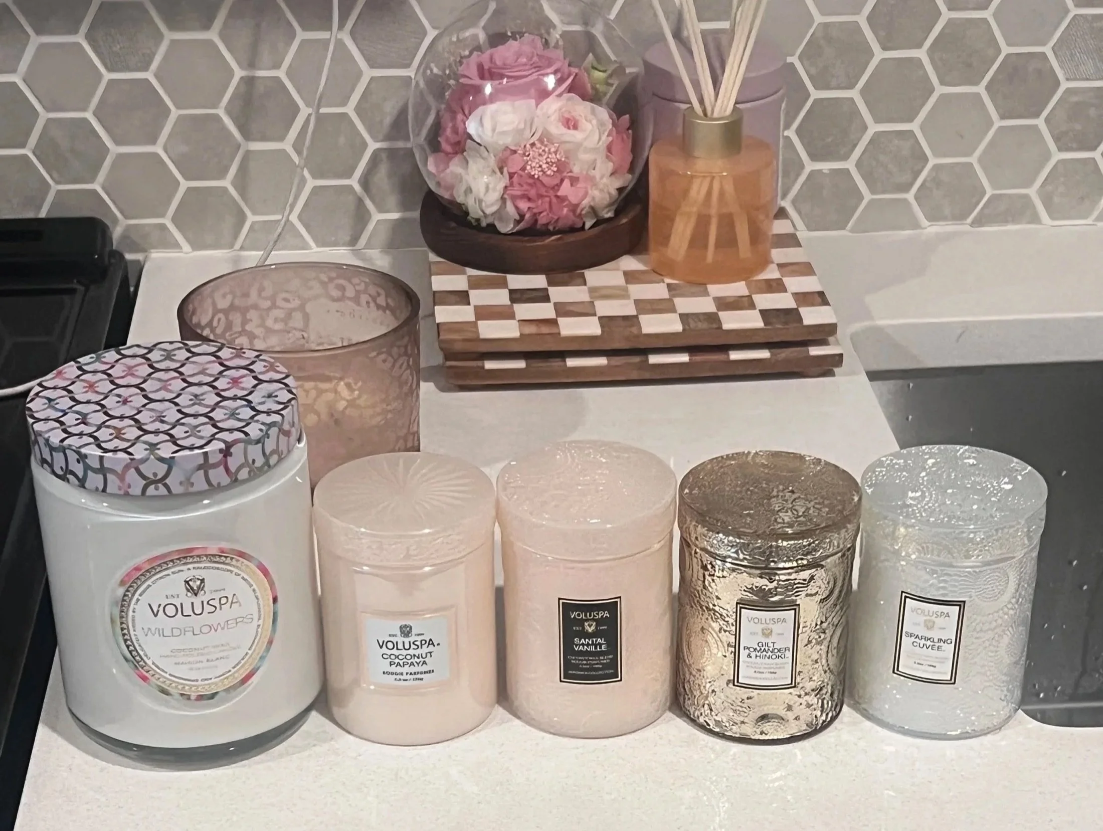 Candles and pink roses on a styled kitchen counter