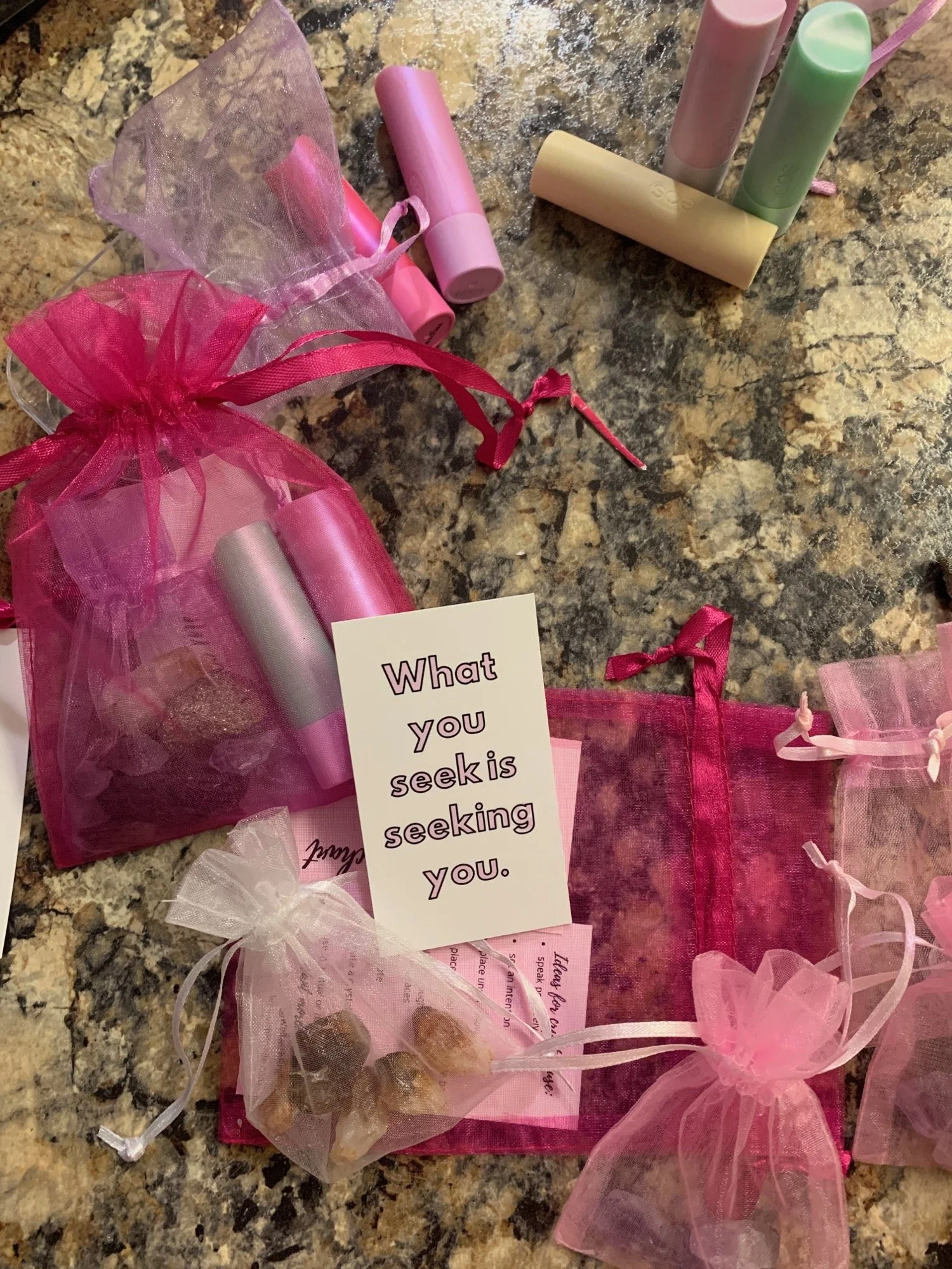 Pink organza gift bags with self care treats
