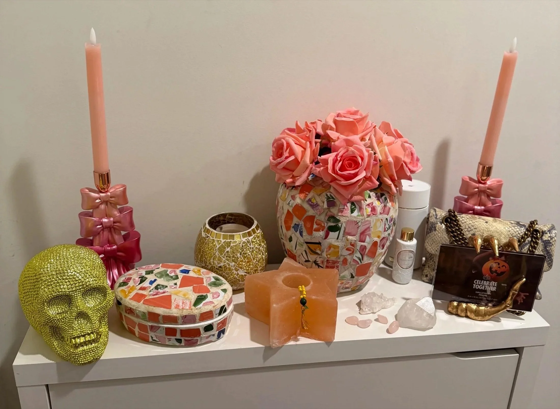 Pretty vanity with roses and colorful candle jars