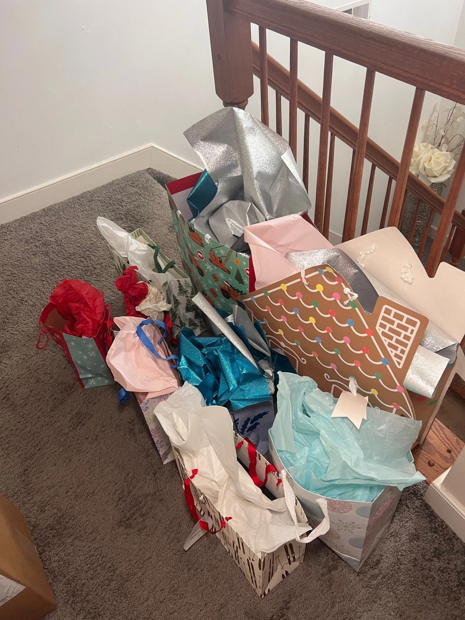 Pile of wrapped Christmas gifts and gift bags