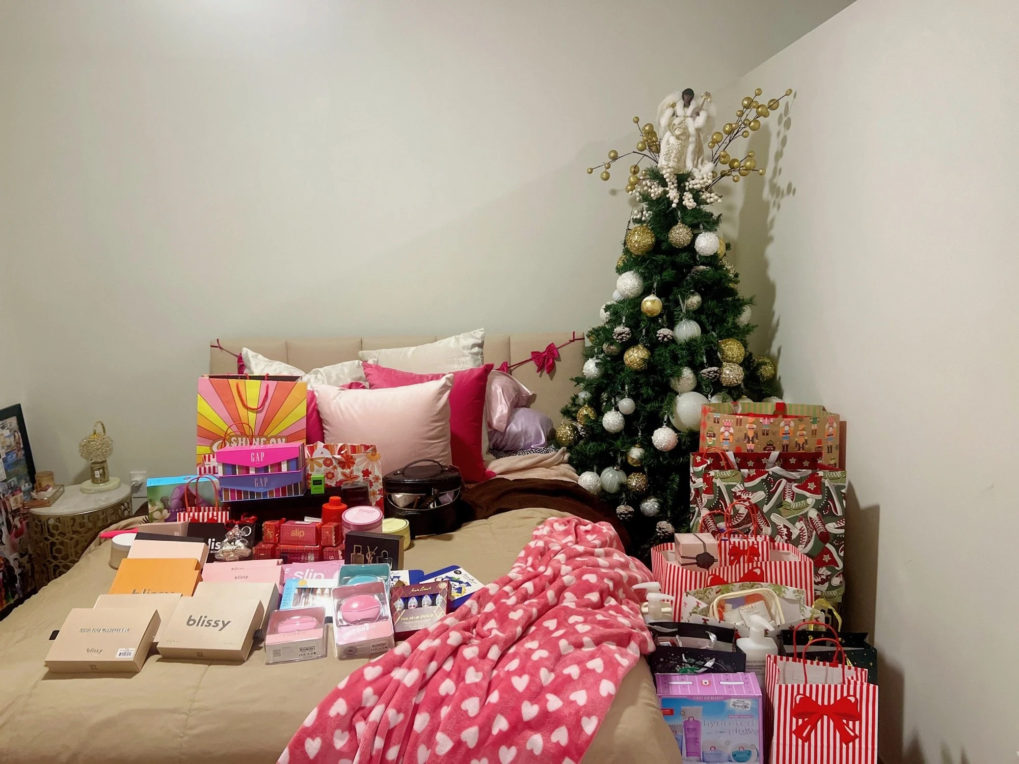 Bedroom full of Christmas gifts by the tree