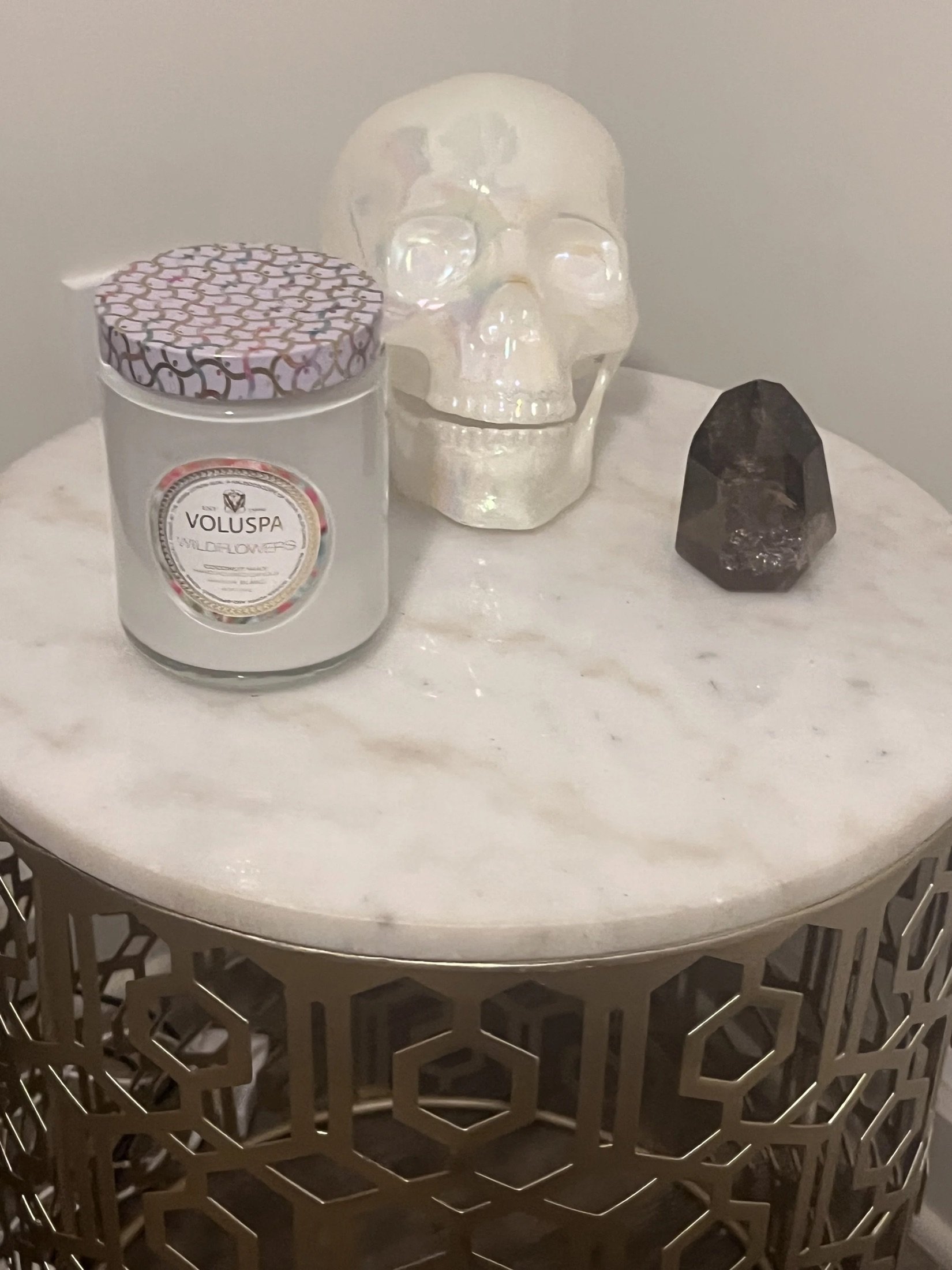 Candle and crystal decor on a marble side table