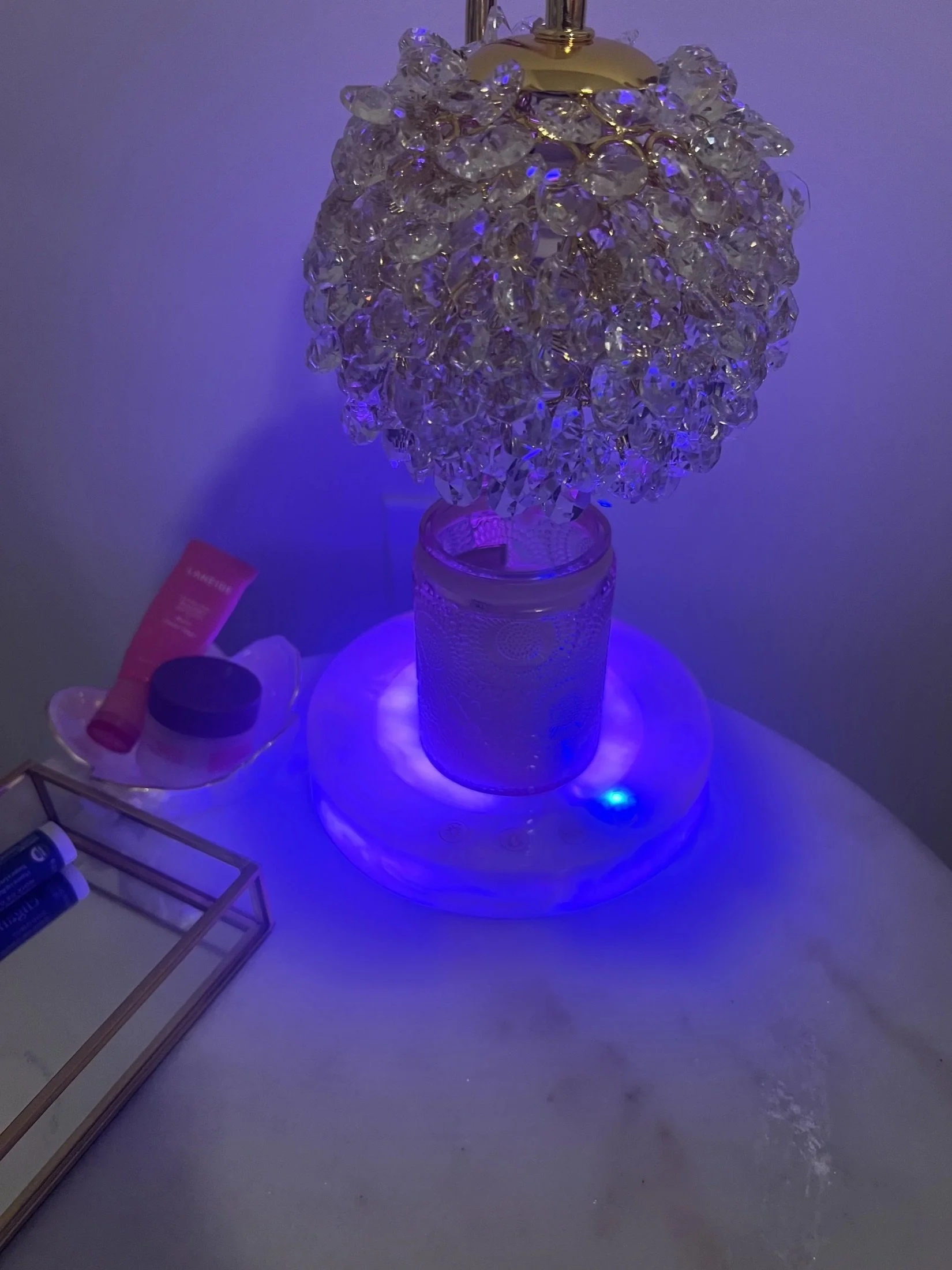Crystal candle warmer lamp glowing purple at night