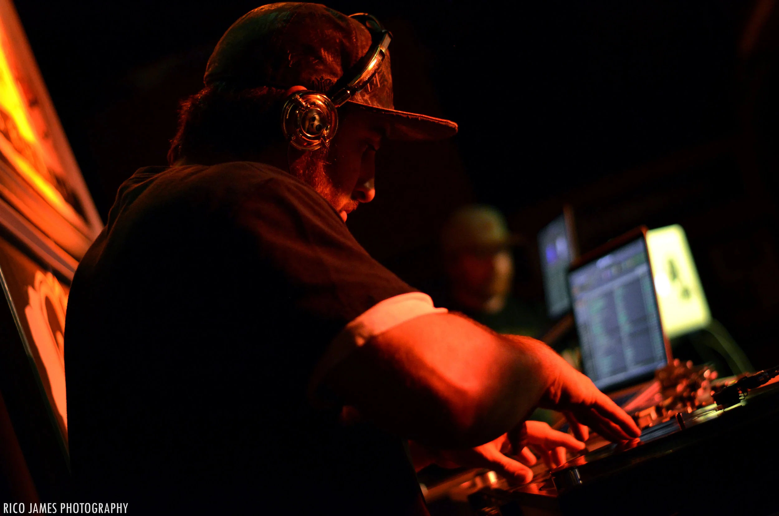 Photo: DJ Kanganade on the decks, courtesy of Rico James