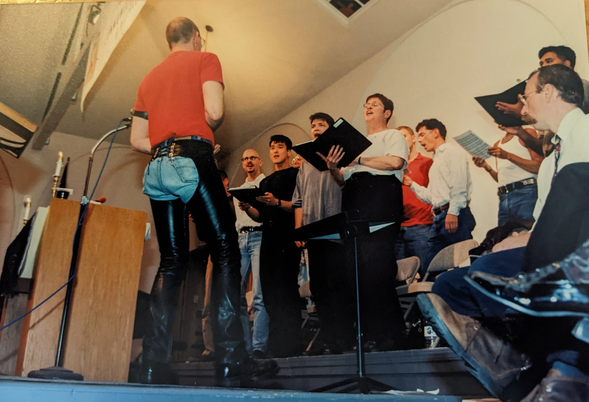  Bob Crocker conducts the choir while Jim Mitulski looks on. Courtesy of Metropolitan Community Church of San Francisco Collection. San Francisco Public Library.&nbsp; 