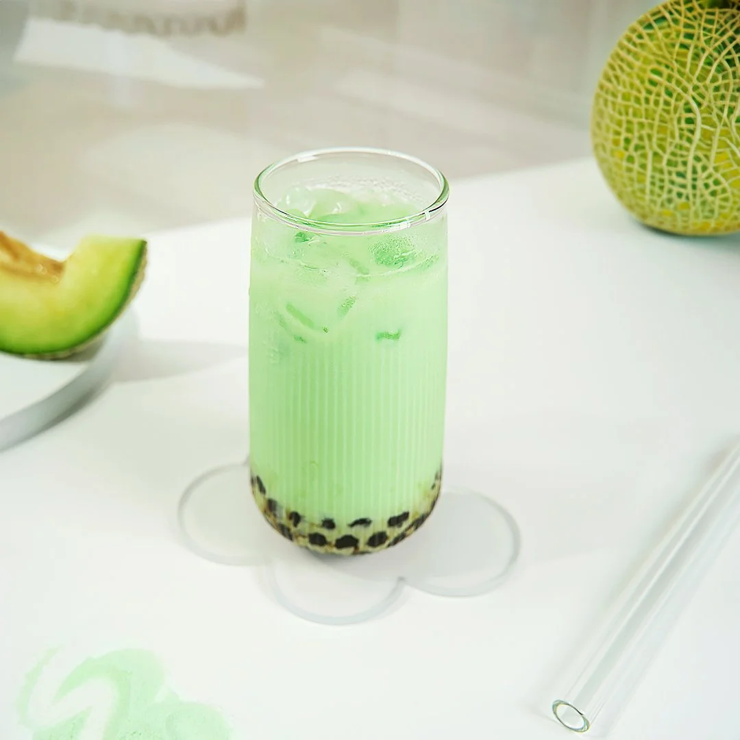 Making milk tea with powder — shaking flavor powder with cane sugar syrup and ice for a consistent café drink