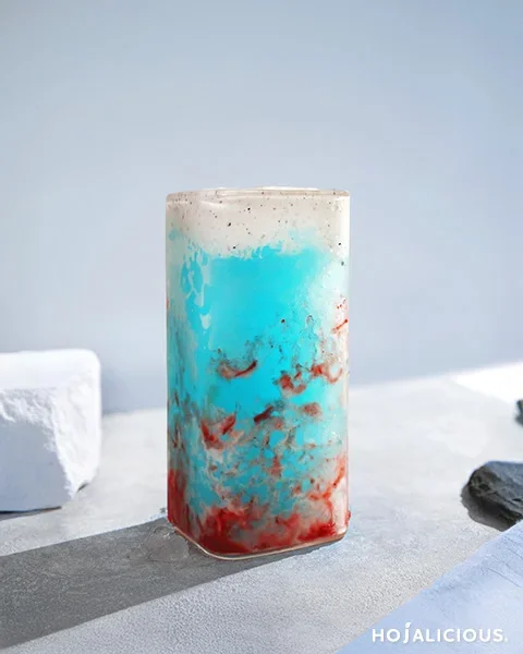 A layered pink and gray strawberry smoothie recipe with cotton candy slush and black sesame milk cap — a soft yet powerful aesthetic drink.