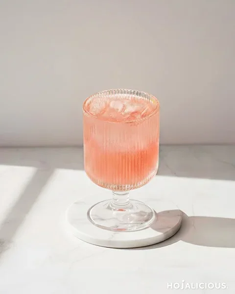 Peach Sakura Drink – light pink coconut water mocktail in a clear cup