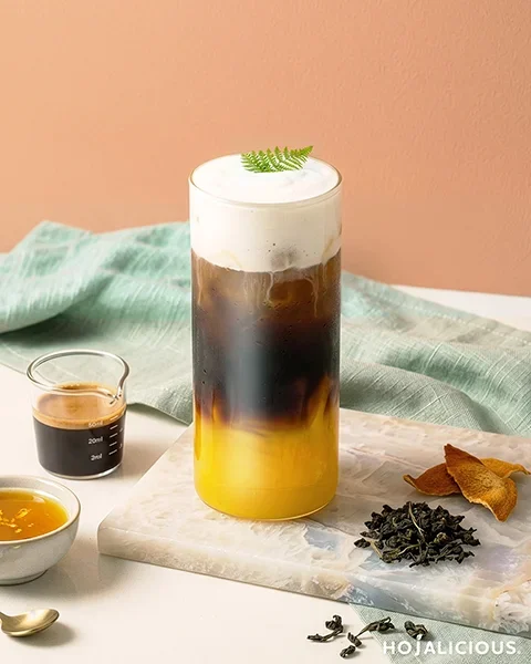 Layered orange oolong cream foam coffee with citrus and espresso