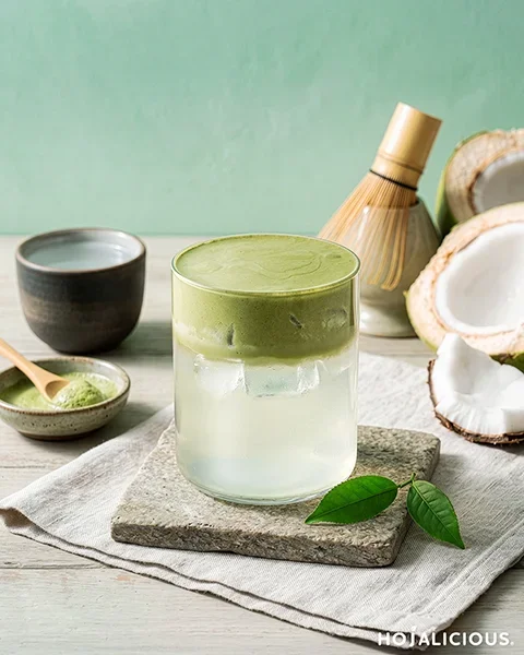 Matcha coconut cream foam drink with layered coconut water and matcha foam