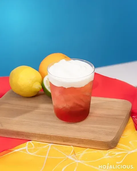 A Strawberry Cream Foam Vodka Tea Cocktail featuring vodka, strawberry syrup, jasmine green tea, strawberry jam, and silky cream foam, creating a refreshing layered summer fruit cocktail.