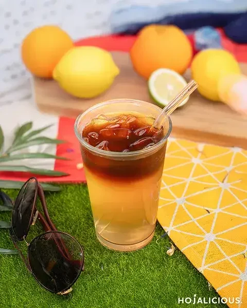 A Lychee Jasmine Cold Brew Coffee featuring jasmine green tea, lychee concentrate, honey syrup, and smooth cold brew coffee, creating a naturally layered Coffee × Tea Hybrid beverage with floral, fruity, and coffee aromas.