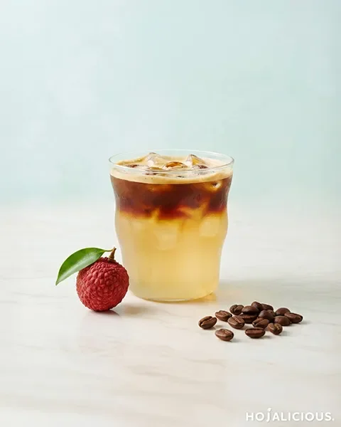 Lychee coconut americano with layered coconut water and espresso