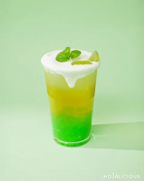 White Grape Cheese Foam Tea layered with green tea, white grape popping boba, and creamy cheese foam topping
