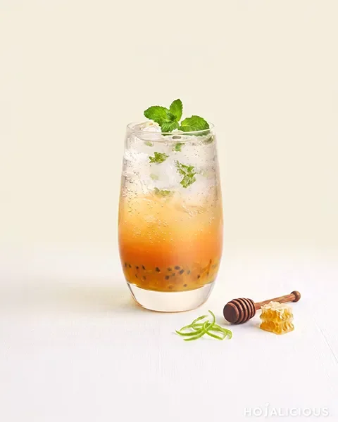 Passion Fruit Mint Soda made with passion fruit jam, longan honey syrup, lemon syrup, fresh mint leaves, and sparkling water for a refreshing tropical fruit drink.