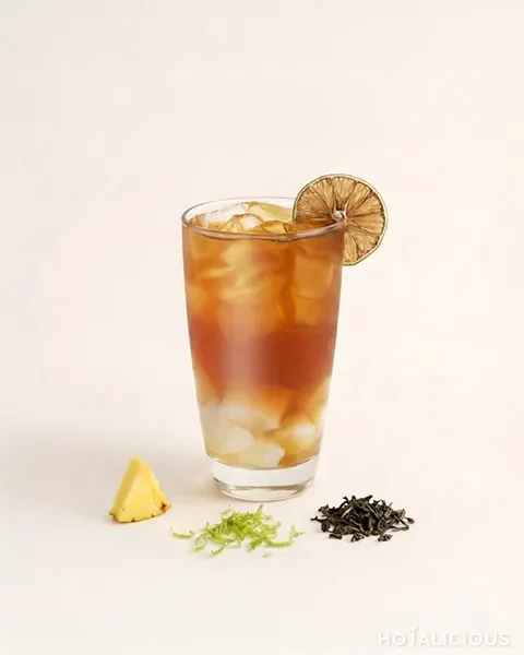 Pineapple Amber Iced Tea made with Tie Guan Yin Oolong Tea, Pineapple Jam, Almond Jelly, and a fresh lemon slice, creating a refreshing fruit tea with roasted tea notes, tropical sweetness, and a silky texture.