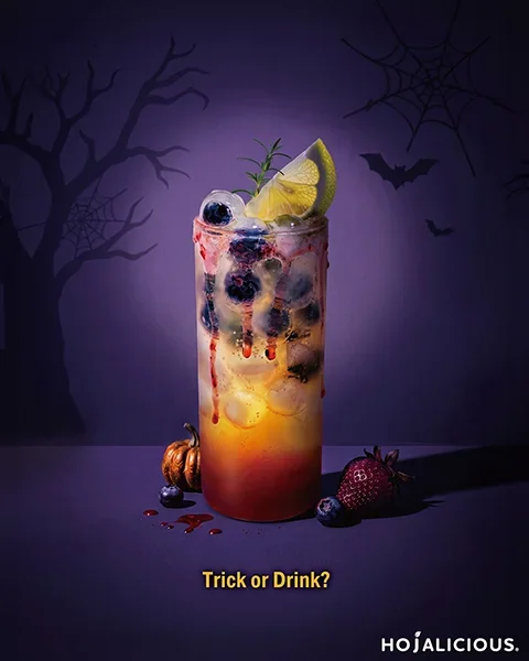 Devil’s Eye strawberry green tea with jasmine tea, muscat grape, blueberry eyeball ice spheres, and red syrup drips for a Halloween drink.