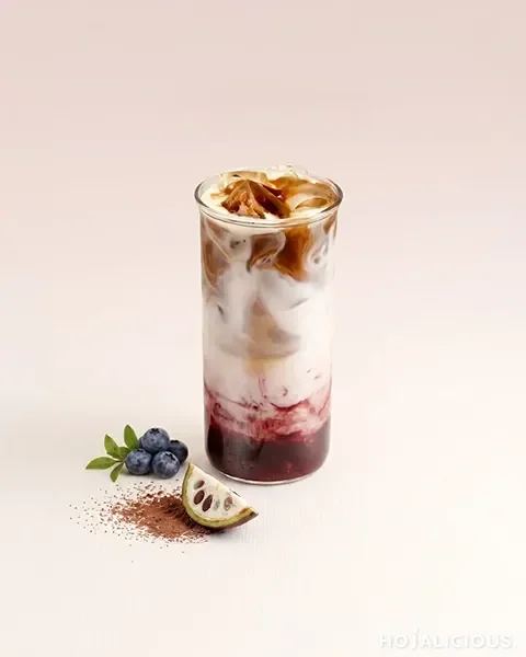 Blueberry Cocoa Latte made with espresso, cocoa sauce, blueberry flavor syrup, fresh milk, and ice.