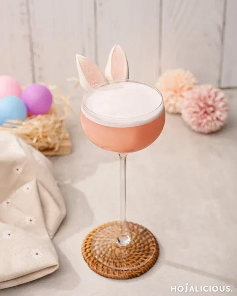 Easy pink gin cocktail with foam top and bunny ear marshmallow garnish