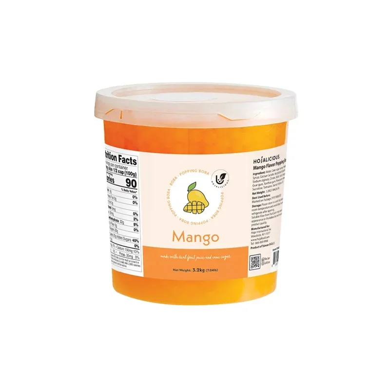 Mango popping boba pearls in a clear cup of fruit tea