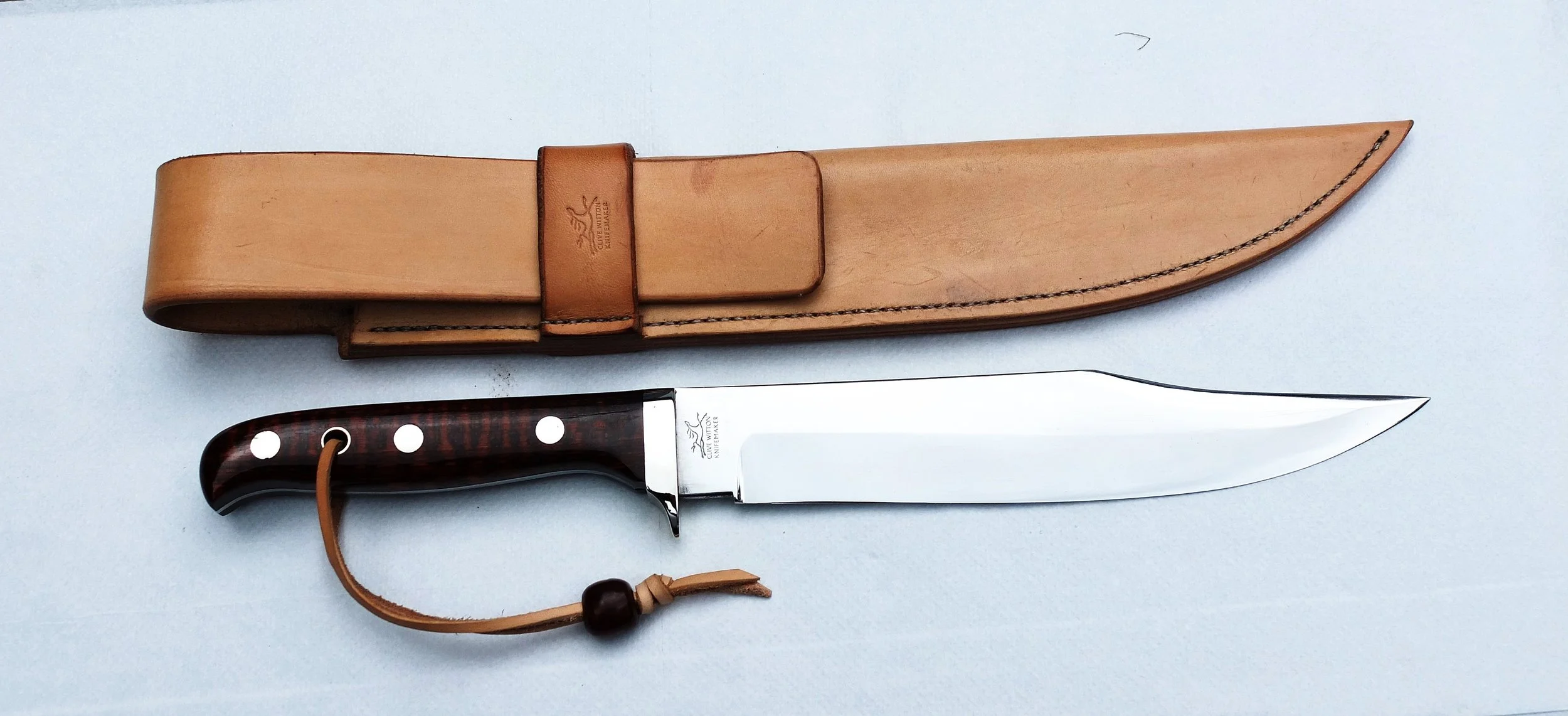 Bowie KnifeA 9" blade in Sandvik 14c28n with a Snakewood handle and nickel silver fittings; hand made and hand stitched sheath in 4 mm thick natural hide.