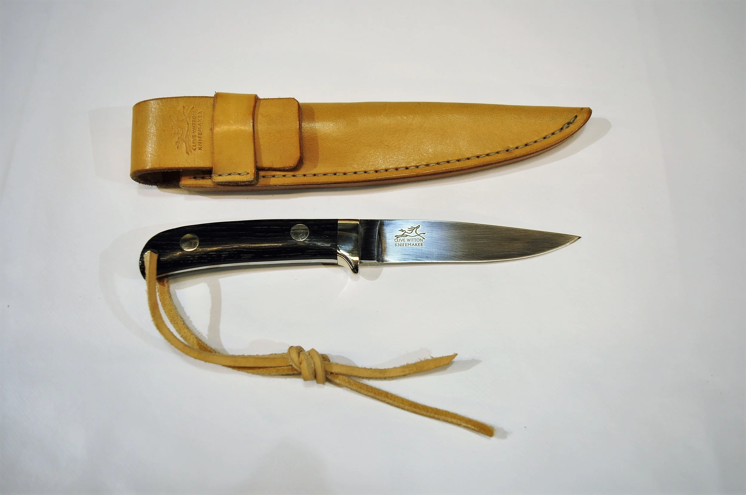 90mm Slim Hunter Slim Hunter 90 mm blade in 14c28n with Neolithic Bog Oak handles and nickel silver fittings, handmade sheath in 3 mm bridle leather.