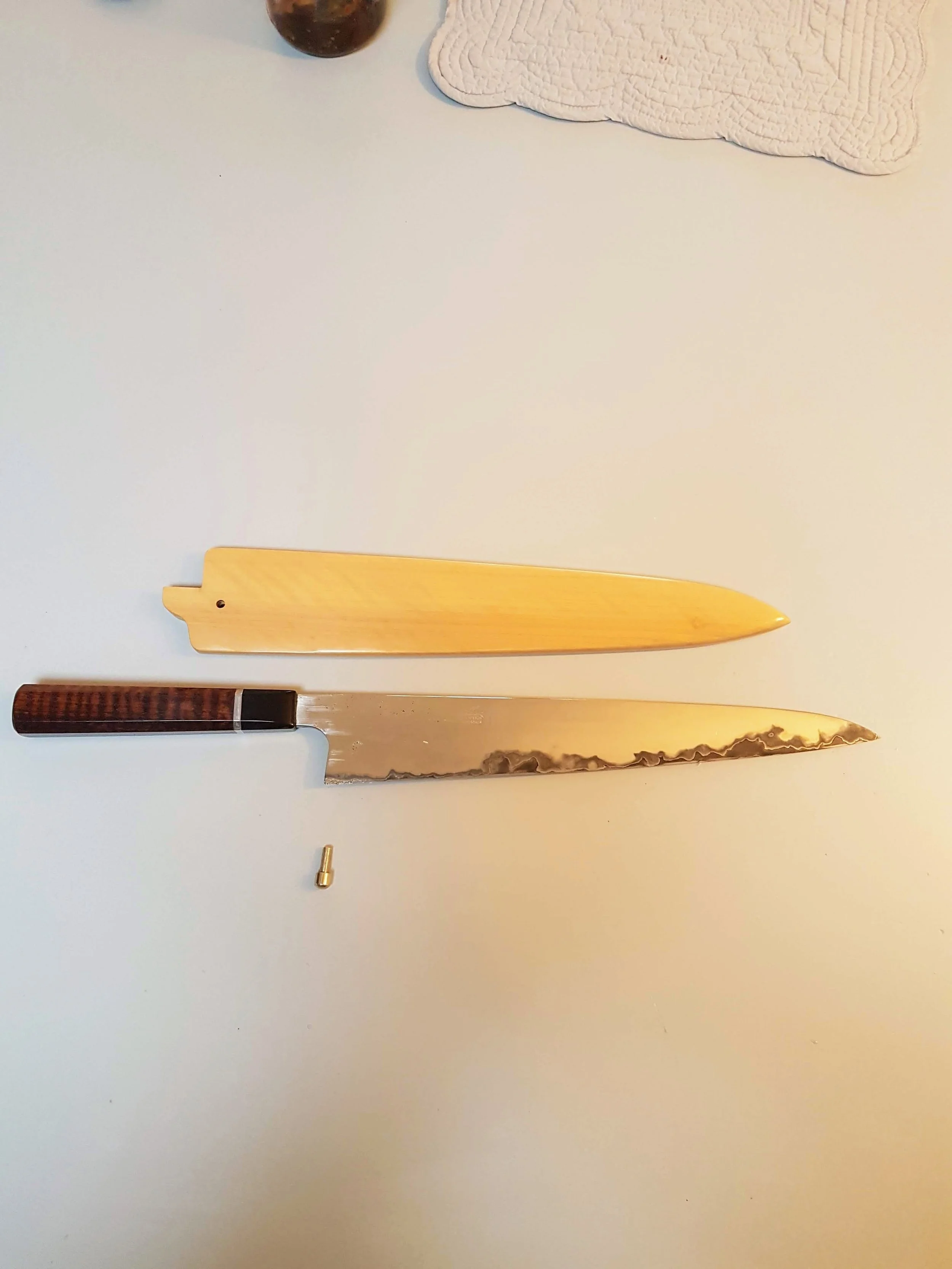 320mm Sujihiki320mm Sujihiki in 125sc and 304L San Mai with a Snakewood, Silver and Buffalo Horn handle and a Lemonwood saya.