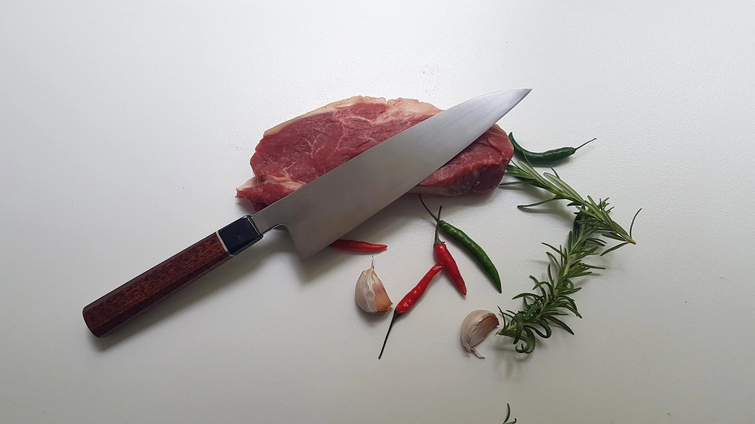 200mm GytuoA 200mm Gyuto in DIN 115W8 (1.2442) Carbon steel, Handle in Snakewood, Silver and Buffalo Horn.