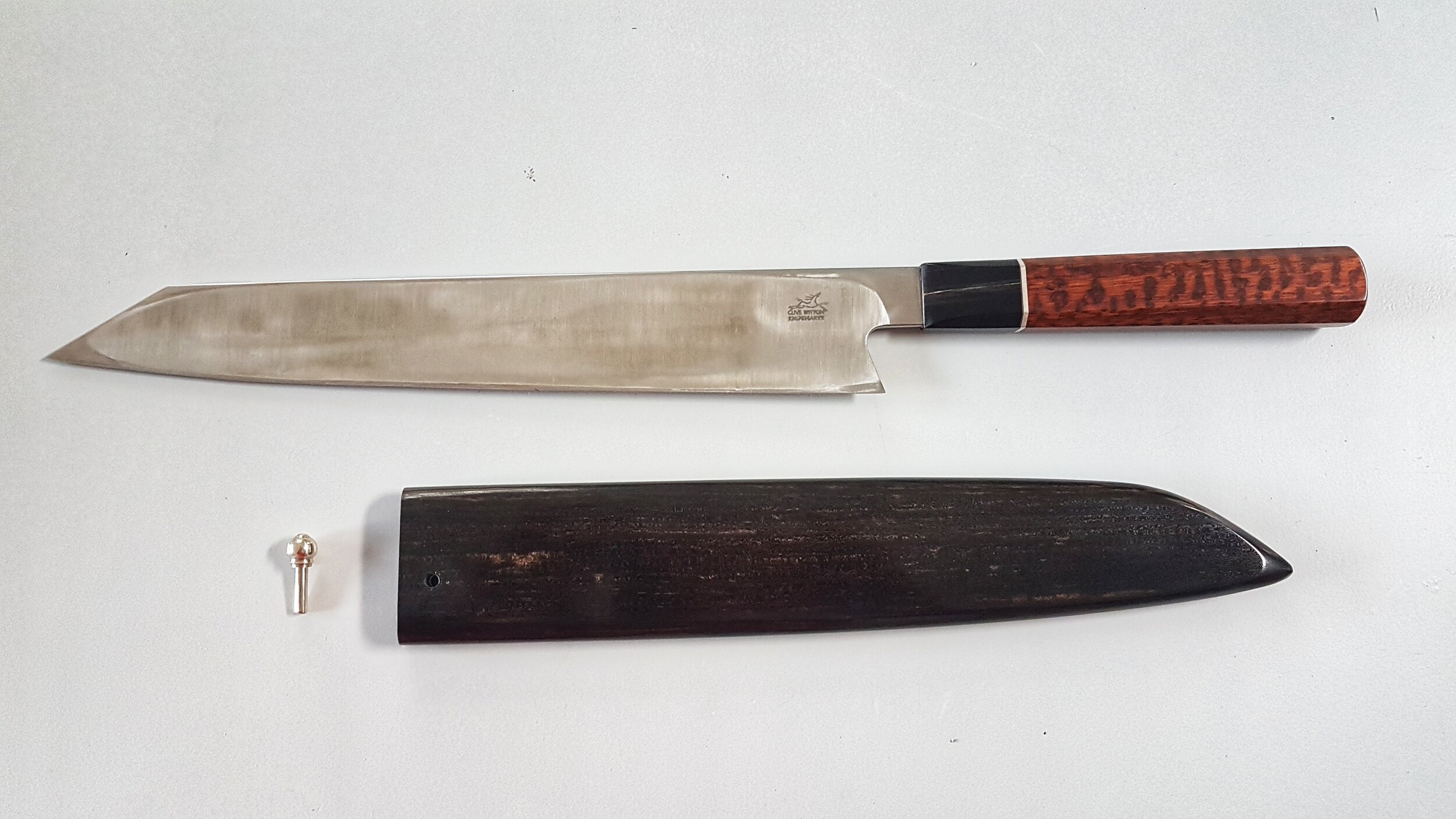 &nbsp;220mm Kiritsuke&nbsp;The blade is 1.2442 is very similar to Hitachi Aogami 1 steel, with a fraction less Carbon and Chromium, but more Tungsten which makes it very hard wearing. The handle is Snakewood (Brosimum Guianense) and originates in th…
