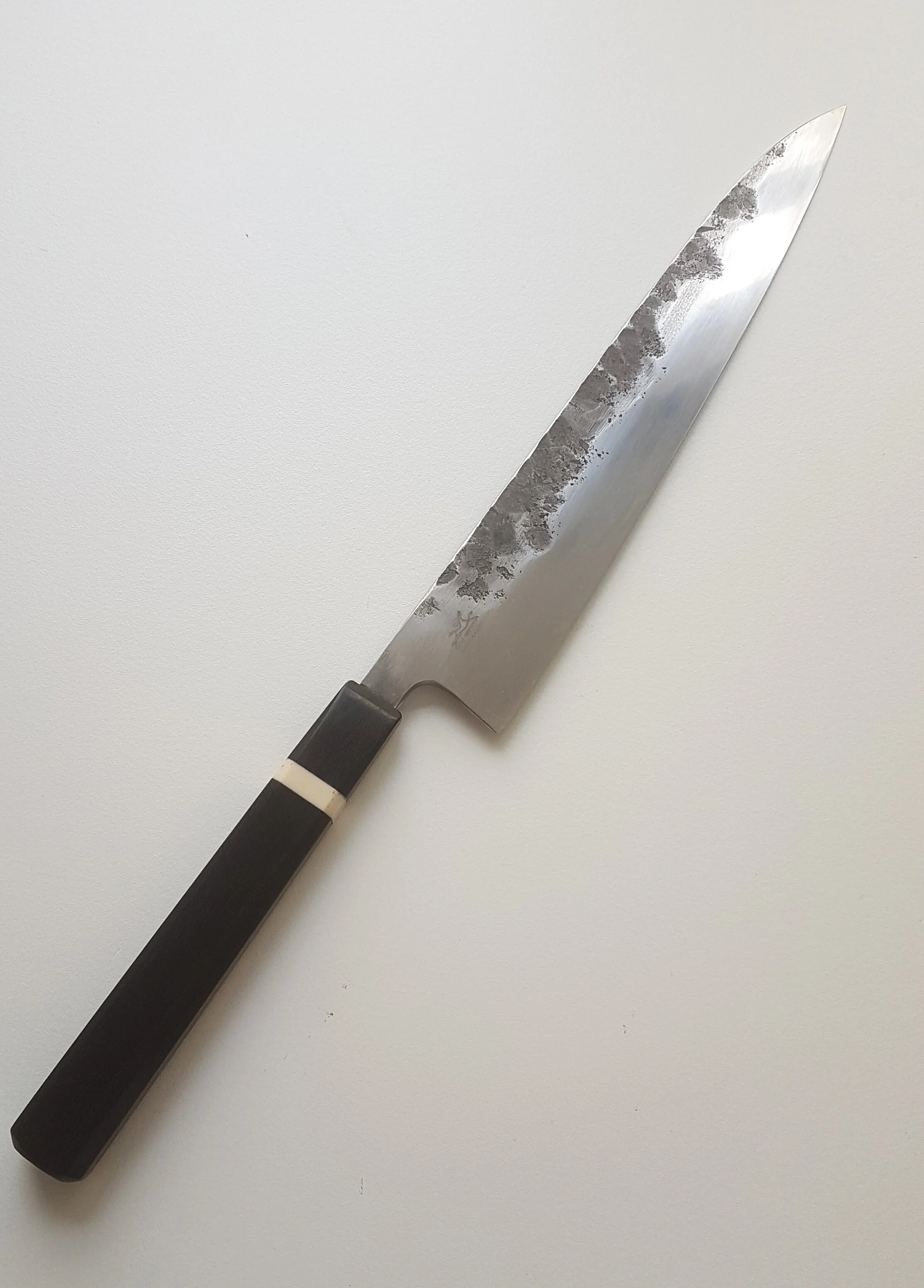 270mm GyutoThe blade is hand-made from 52100 steel, AISI L3 and is mostly recognised in its use for ball bearing manufacture. The composition is nominally Carbon 1.0%, Chrome 1.3 – 1.7%, Vanadium 0.1 – 0.3%, Manganese 0.25 – 0.8%, Silicon 0.25 – 0.8…