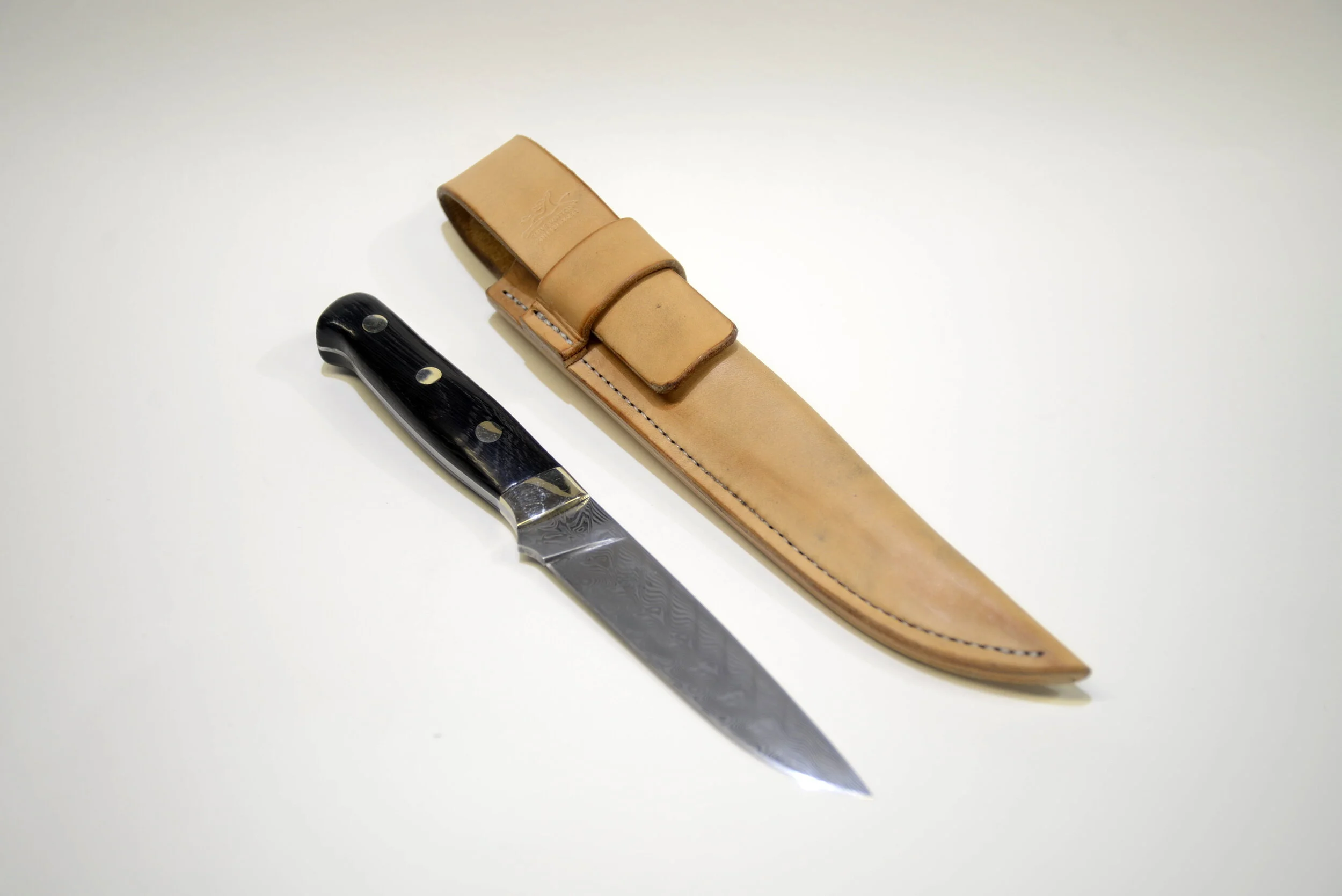 5” Fixed Blade HunterThis Drop Point Hunter has been formed from a piece of Damasteel’s Damascus patterned stainless steel; this is a highly specialised powder steel with two alloys, RWL34TM and PMC27TM, which can be seen in the etched surface. Powd…