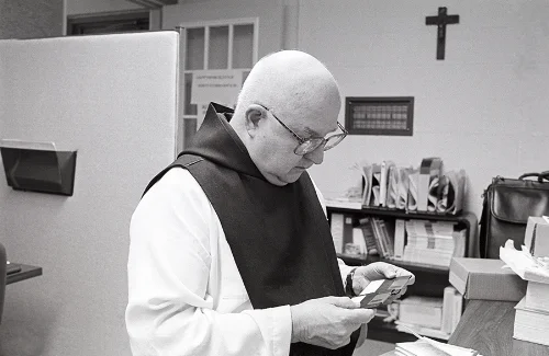 Father Paschal Balkan studying the back-up disks.