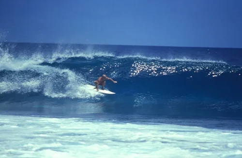 Yvon Chouinard, Patagonia’s maverick founder surfing near to the office. Chouinard explains how the recession of 1991 nearly closed the company. During crisis talks they decided to limit growth of company to 5% per annum and to start making jackets from recycled polyester in 1993. © Patagonia (2010)