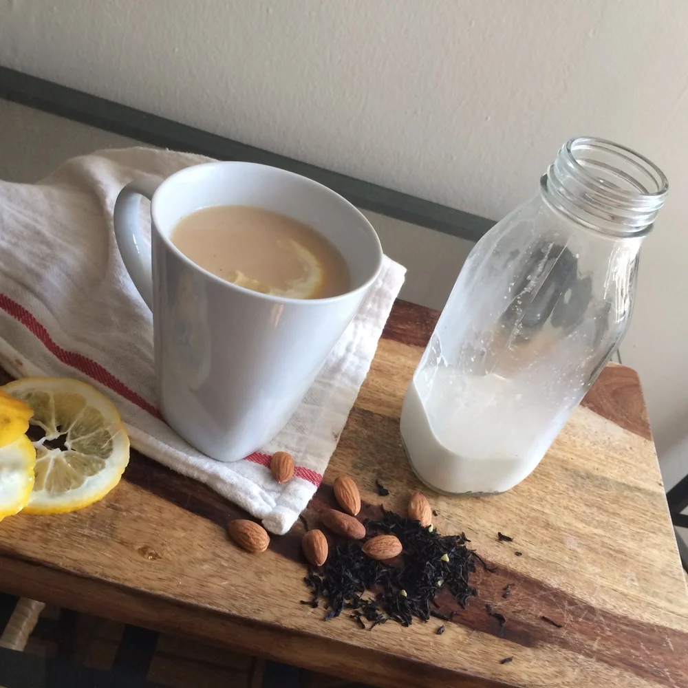 This Roasted Vanilla Almond Milk not only showcases the almond milk, but also gives a hint of how to use it: simply mixed in a hot cup of tea with a slice of honey. The wood background, looseleaf tea, homely tea towel, and whole almonds also contribute to the rustic styling of this photo. 