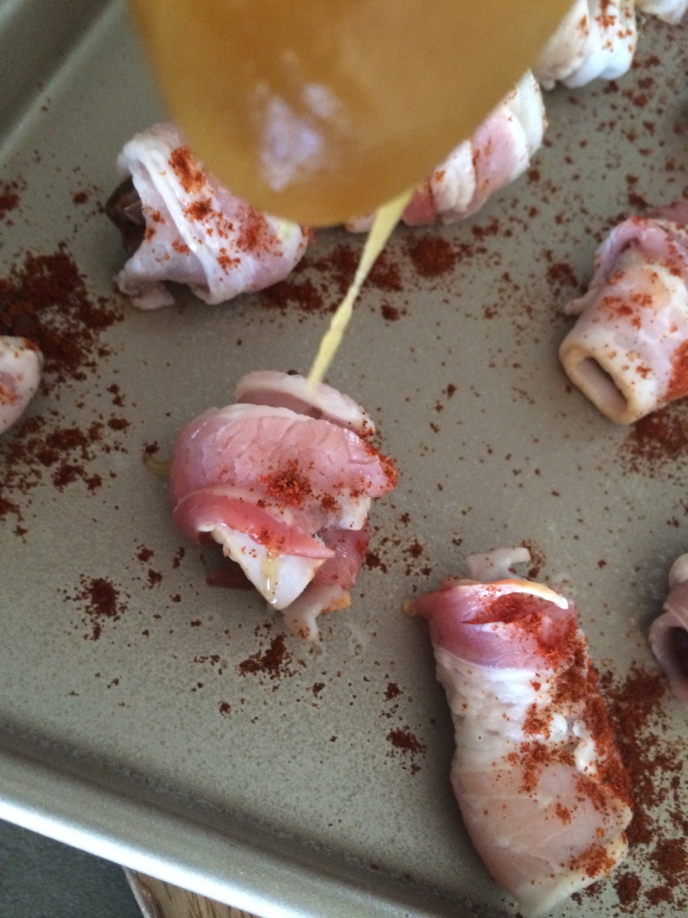 An "action shot" of these Sweet n' Spicy Bacon Wrapped Dates adds a different perspective. 