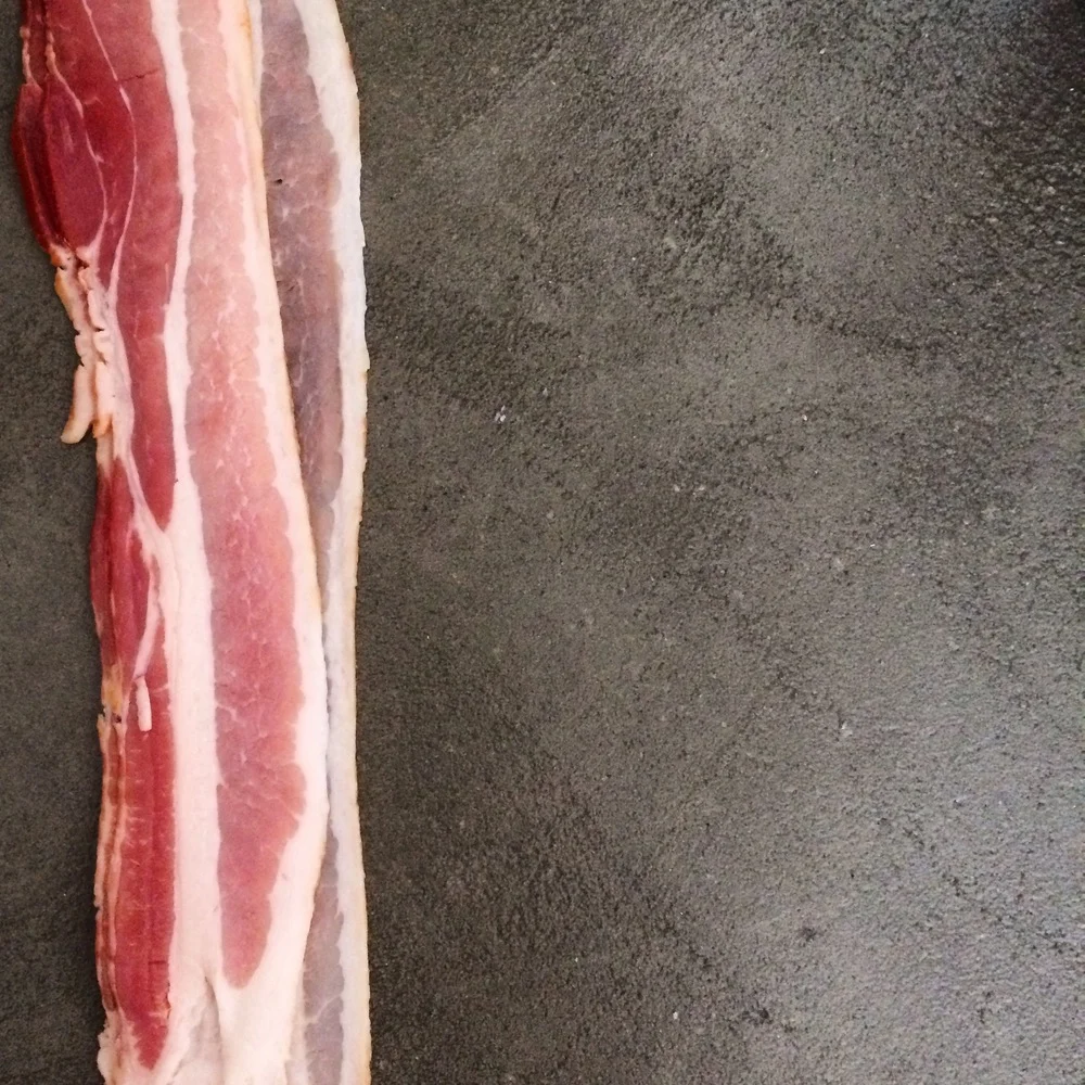 Here, this slice of bacon takes up the left, vertical third of the photo. Taken from Sweet n' Spicy Bacon Wrapped Dates . 