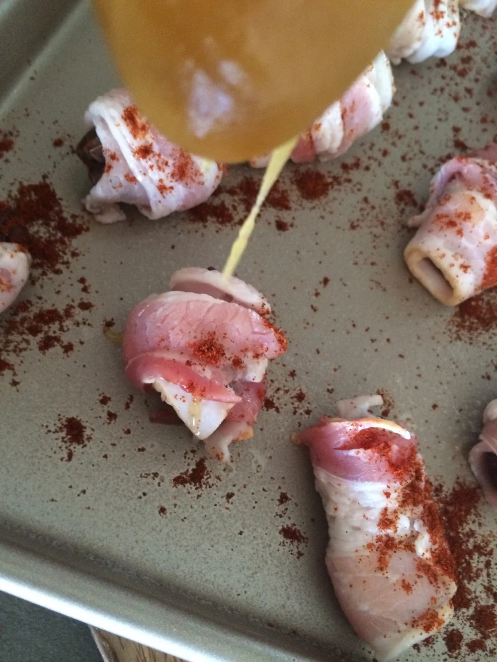 An "action shot" of these Sweet n' Spicy Bacon Wrapped Dates adds a different perspective. 