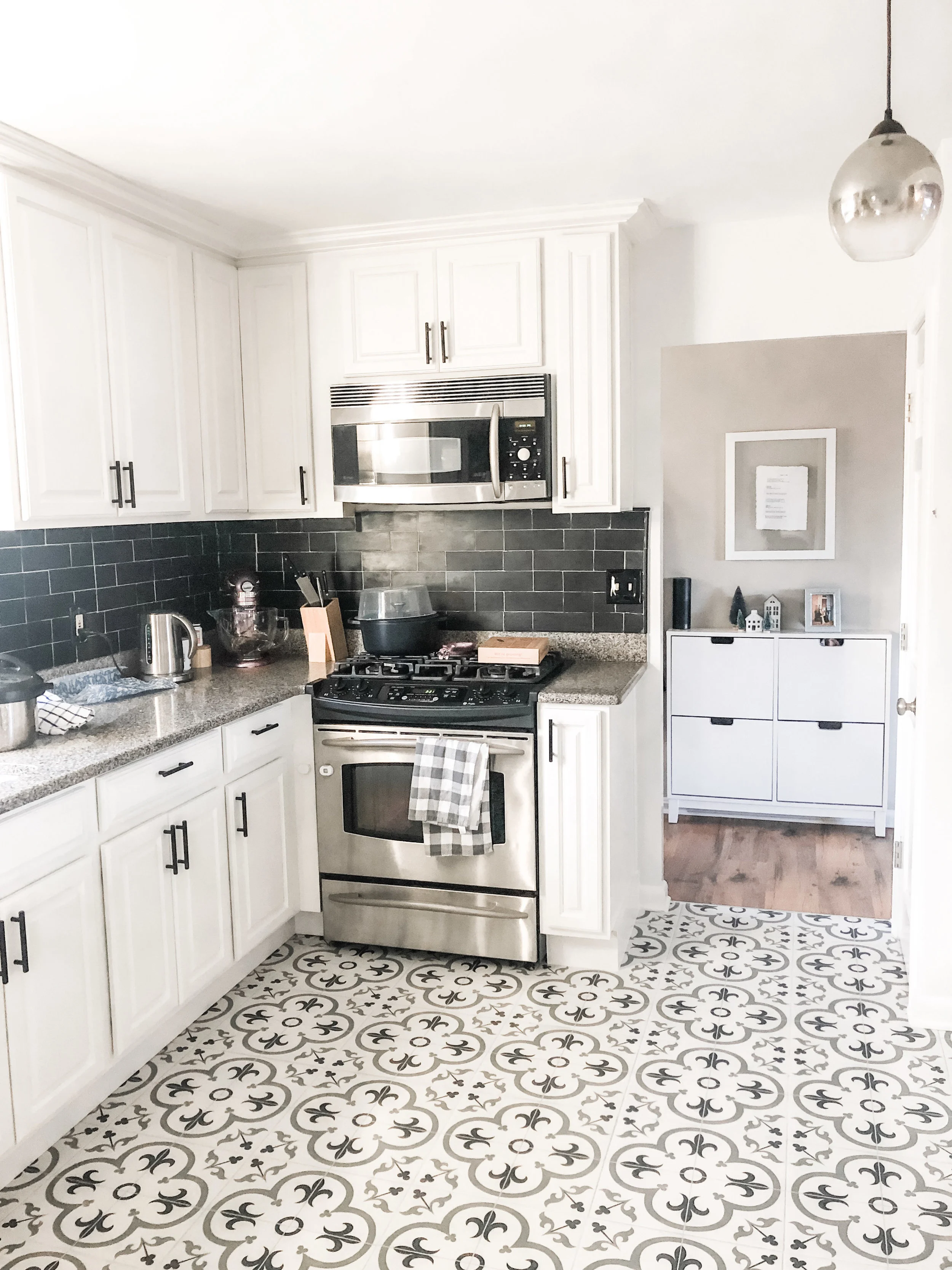 Finished kitchen! So glad I went with the black and white colors earlier this fall when I repainted the cabinets and installed the black backsplash. The patterned tile really pulls everything together.