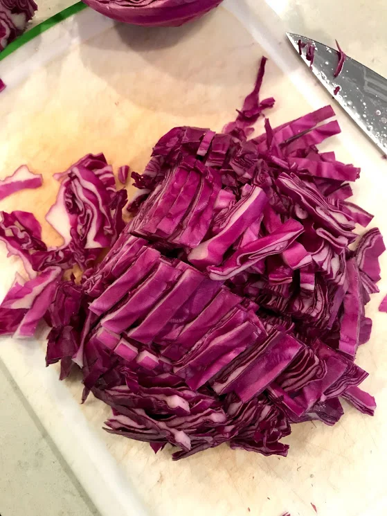 I cut my cabbage into fourths and then slice, so I don't have a long string on cabbage hanging from my mouth at dinner.