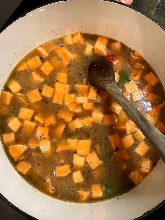 Sweet potatoes, tomatoes, and compliant broth are added to the pot. What does compliant mean? Many broths add sugar, colorings, yeast, and starches. A compliant broth does not contain any of these things, you are looking for minimal ingredients, as if your grandma made it back in the day.