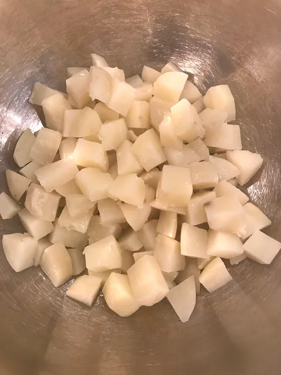 Put the drained potatoes into a large bowl, you want it to be large because all the veggies will go in there and you want enough room to mix and toss with dressing. Let it chill in the fridge, I do this in the morning and then do errands or something while it cools.