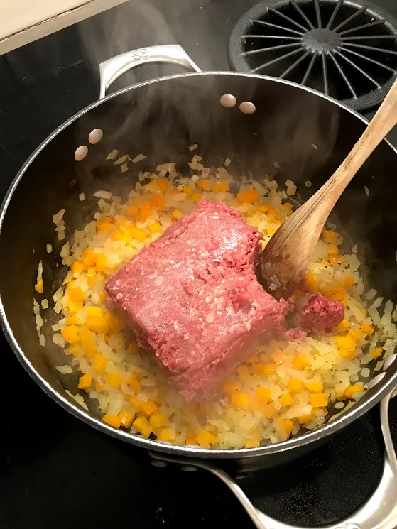 Get that beef in there once the onions and peppers are soft and some bits are browned. Break up the meat and cook through.