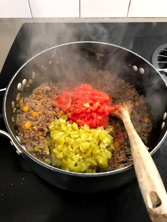 Get can crazy and dump in the tomatoes, chiles, and enchilada sauce. I prefer the petite diced tomatoes because, well, they are smaller than the regular dice. And it's harder for a kid to pick out, shhhh!
