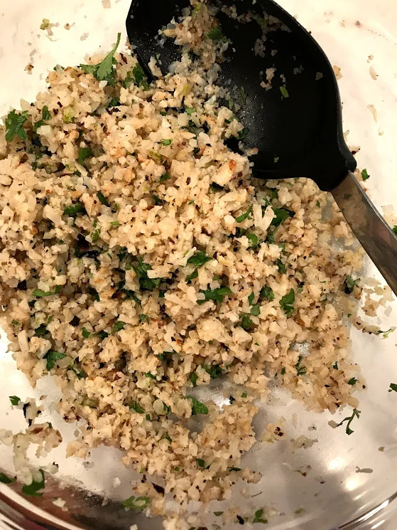 Now take that cauliflower rice and add the cilantro, zest, and juice of the lime. Totally takes it to the next level, Chipotle knew what they were doing when they made rice this way.